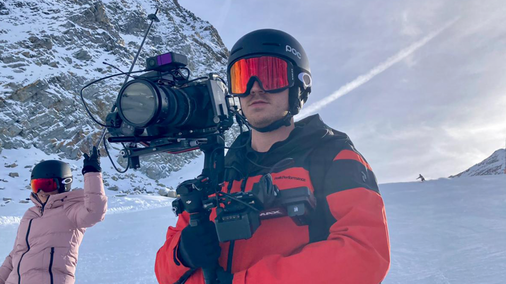 Max Everett capturing footage in the snow with a camera.